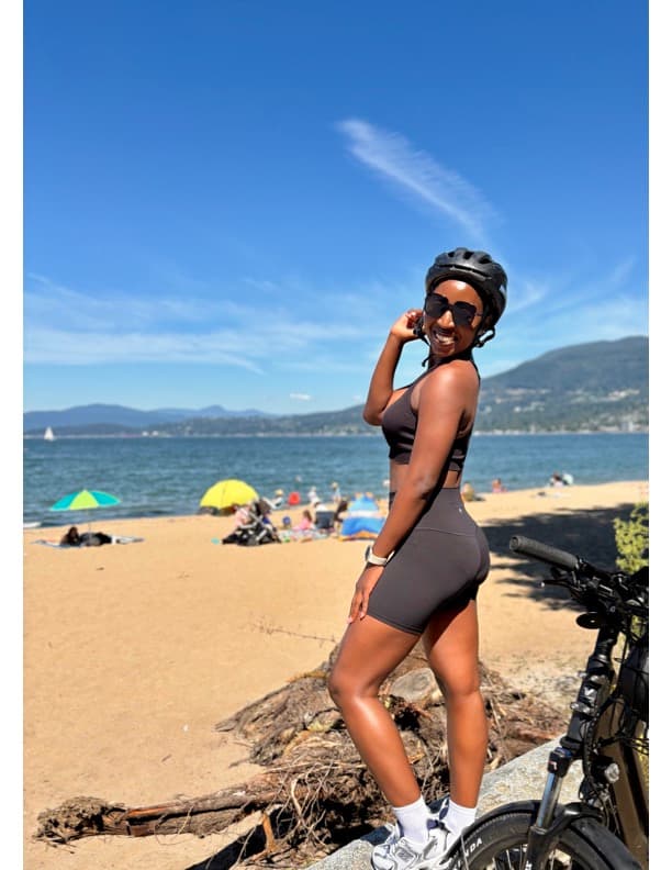 Gloria with her bike at a Vancouver beach, side profile