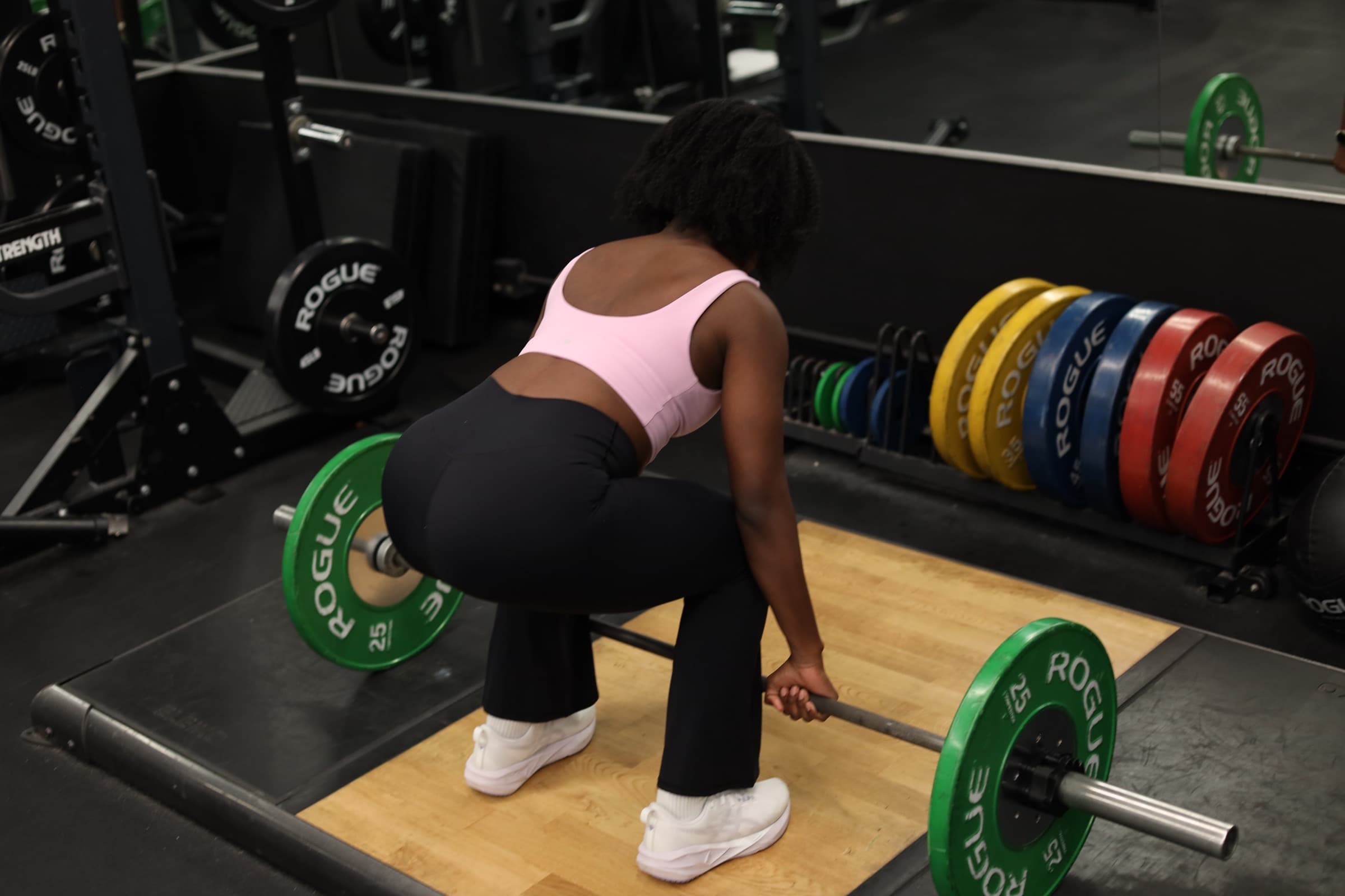 Gloria setting up a deadlift in the gym